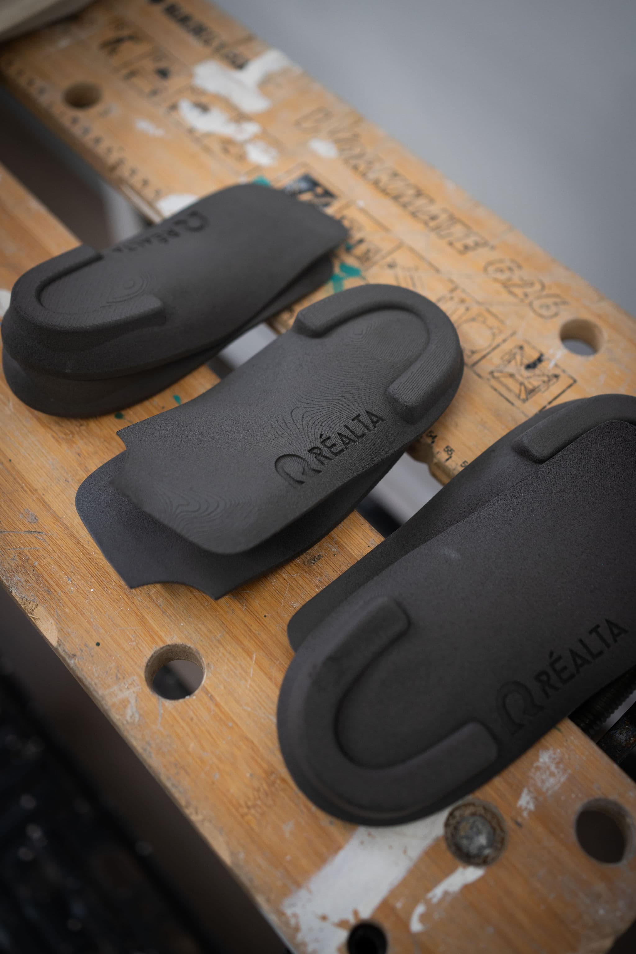 Orthotic shells and materials laid out on the Réalta workbench