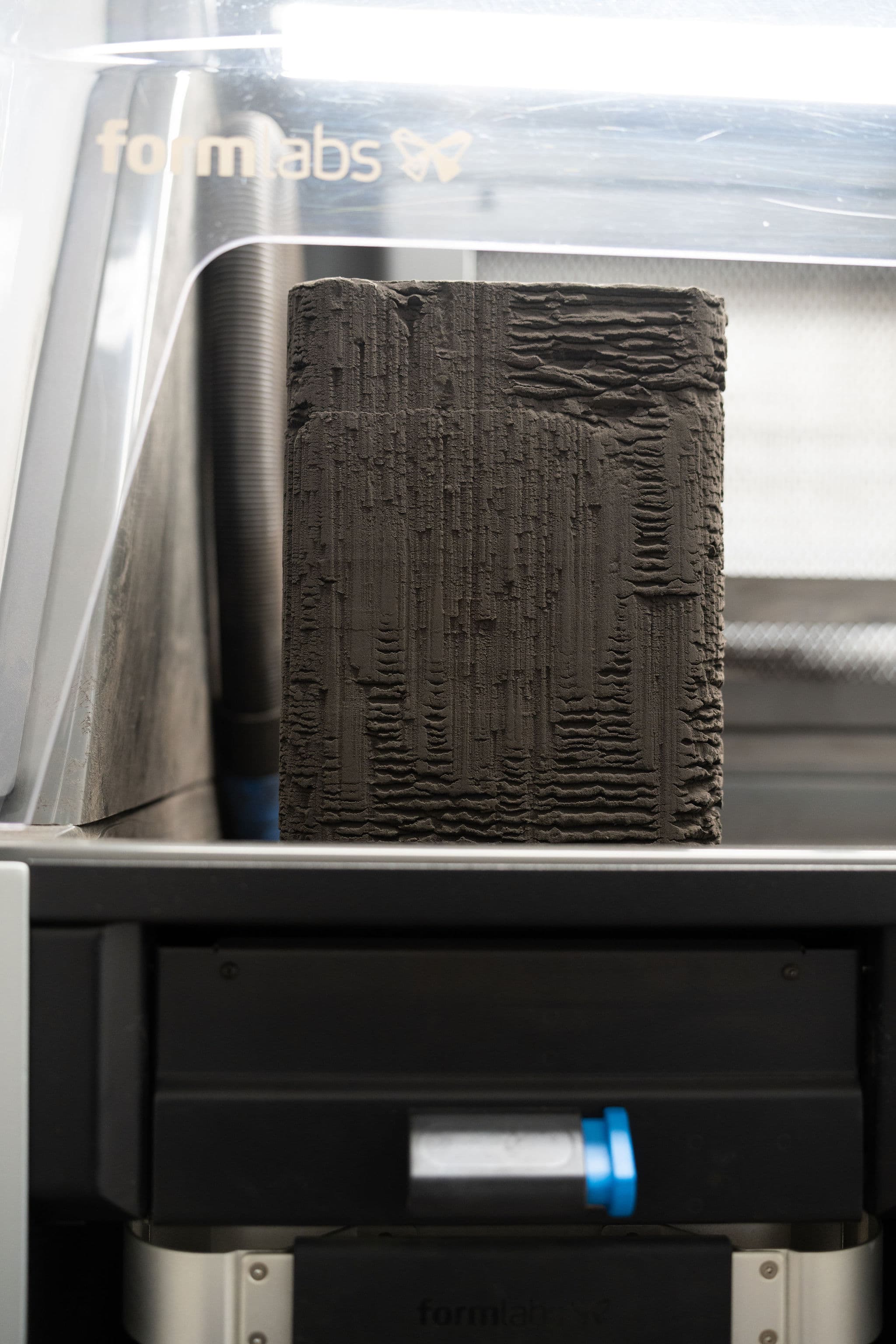 SLS print cake inside Formlabs printer showing fused orthotic shells