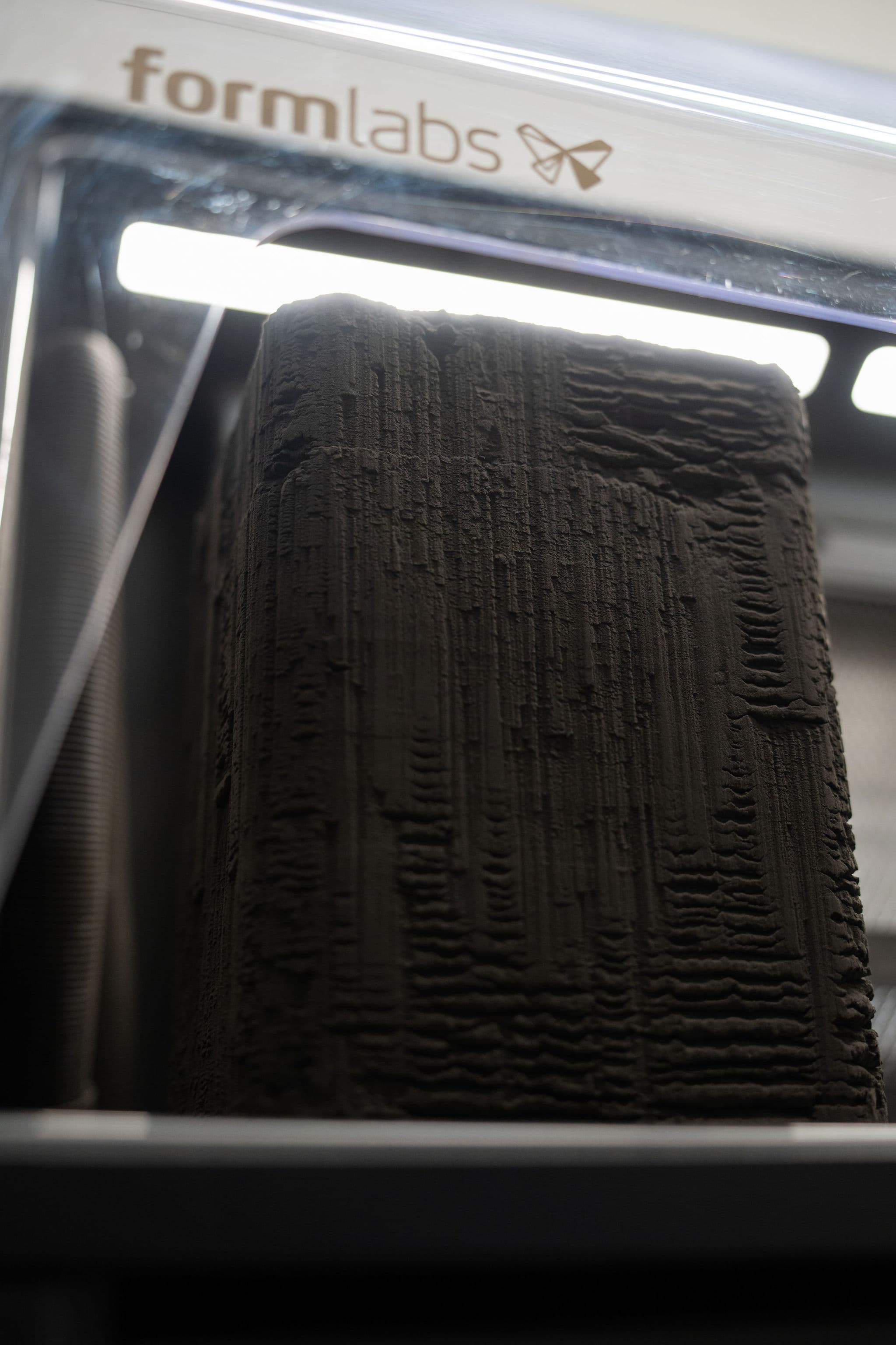 SLS print cake inside Formlabs printer with orthotic shells