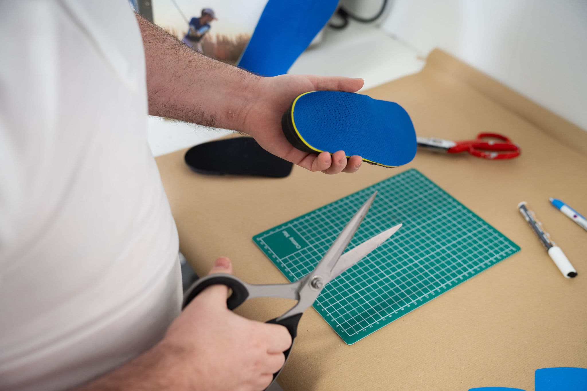 Technician trimming a top cover by hand
